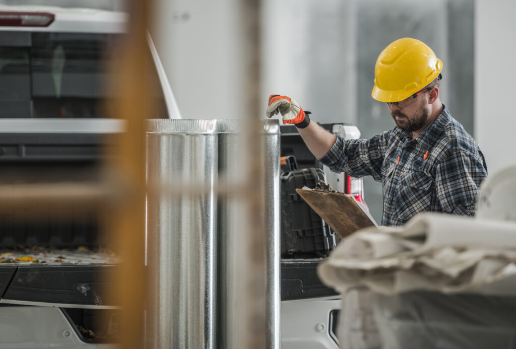 Worker Preparing HVAC Air Circulation Elements For an Installation